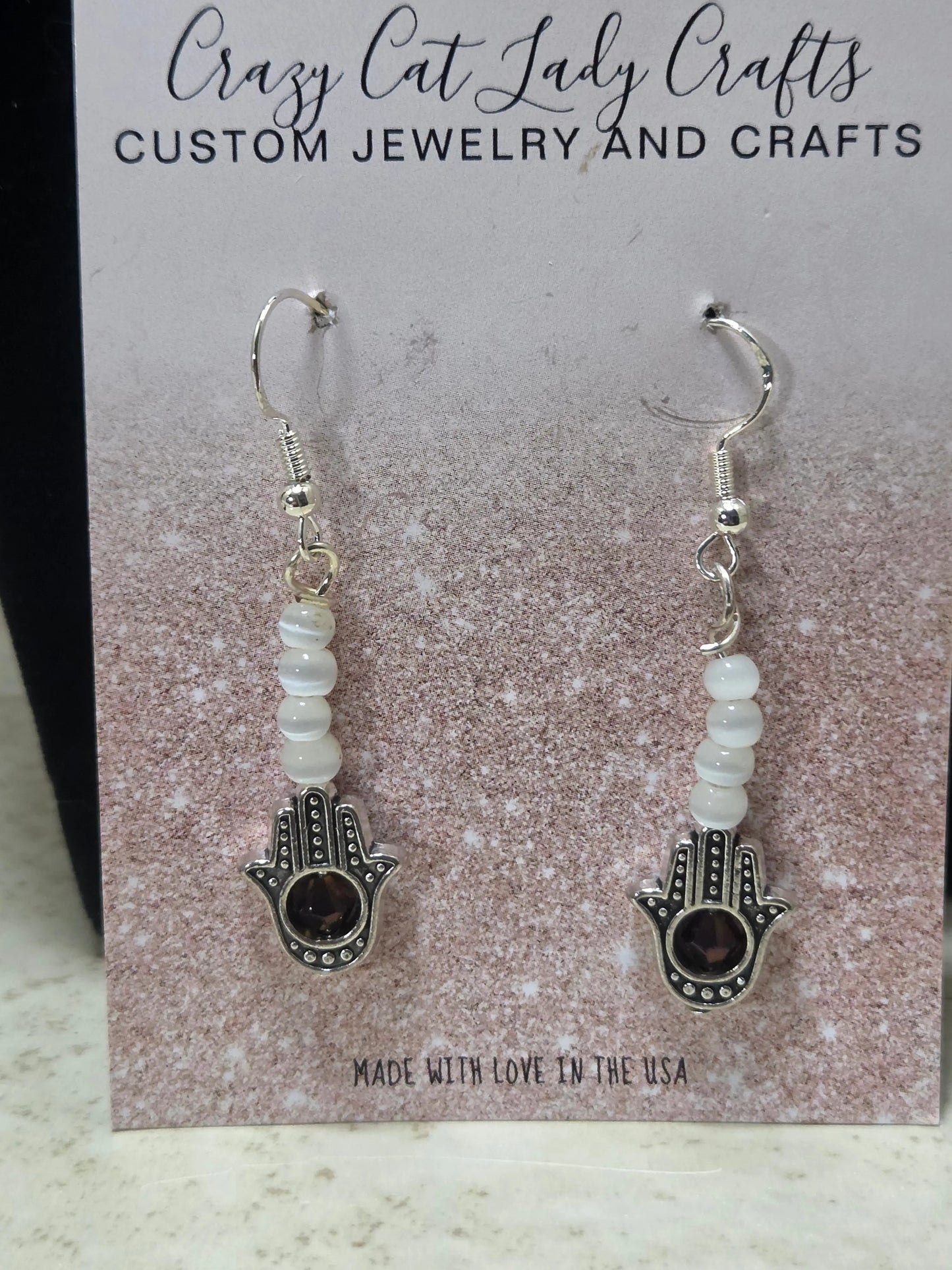 Pointing up Hamsa in silver white and purple stone in the middle earrings - Crazy Cat Lady Crafts