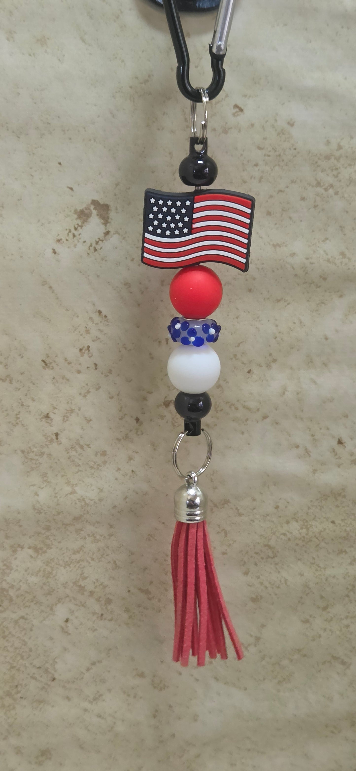 American flag with red white and blue beads and red tassel bag tag