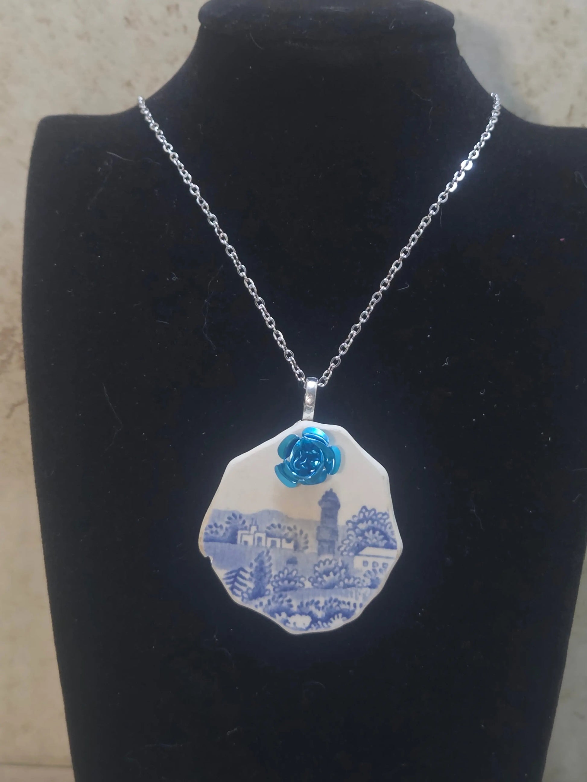 2 inch blue painted ceramic scene with a metal rose added  to make a a beautiful  and unique pendant necklace - Crazy Cat Lady Crafts