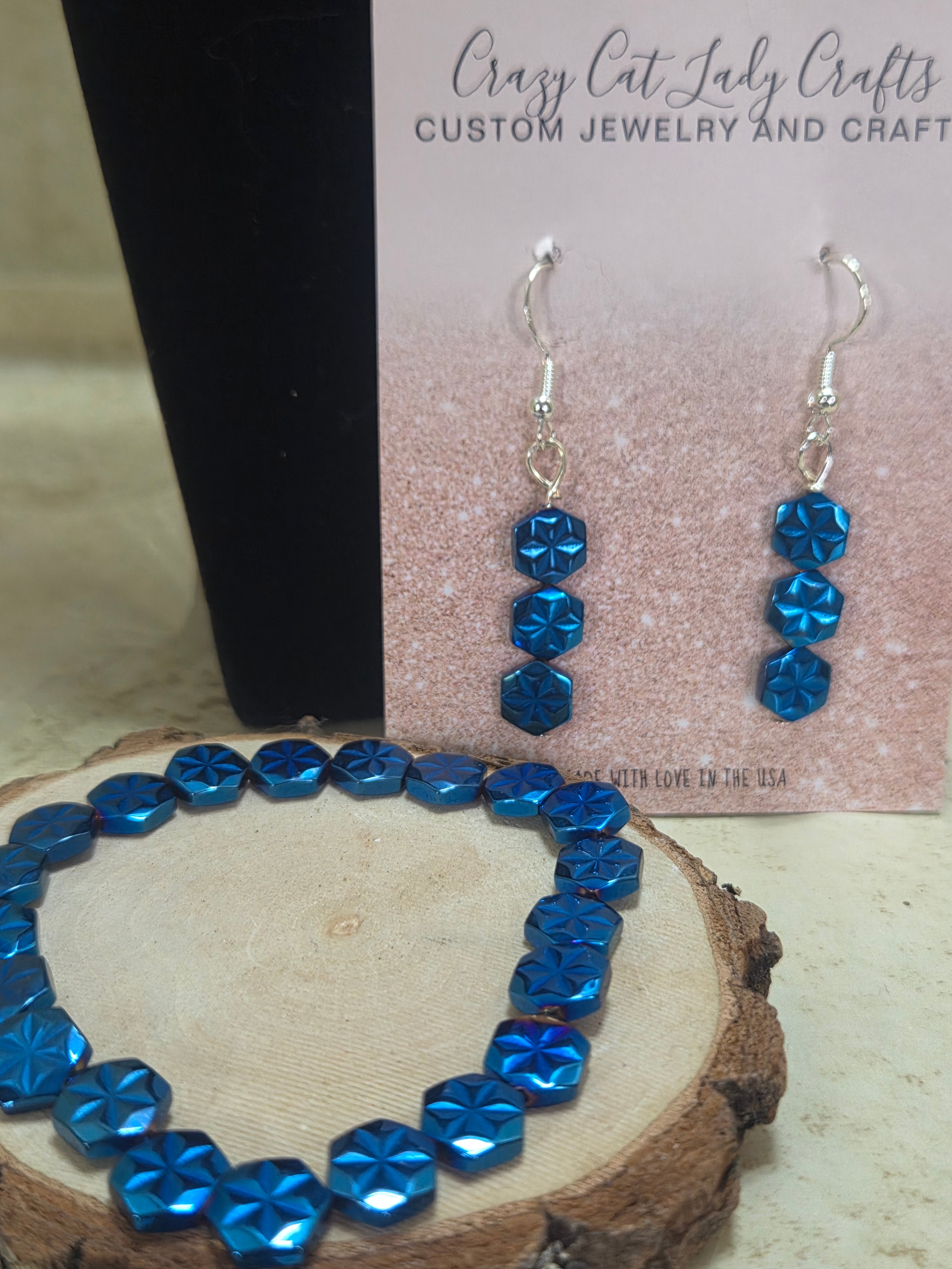 Metallic blue stretchy bracelet in flower flat beads in size 7.5" and matching earrings 2 PC jewelry set