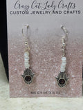 Pointing up Hamsa in silver white and purple stone in the middle earrings - Crazy Cat Lady Crafts