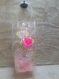 12 inch high plastic bag with handles has pink shreds and a pink and white metallic roses inside - Crazy Cat Lady Crafts