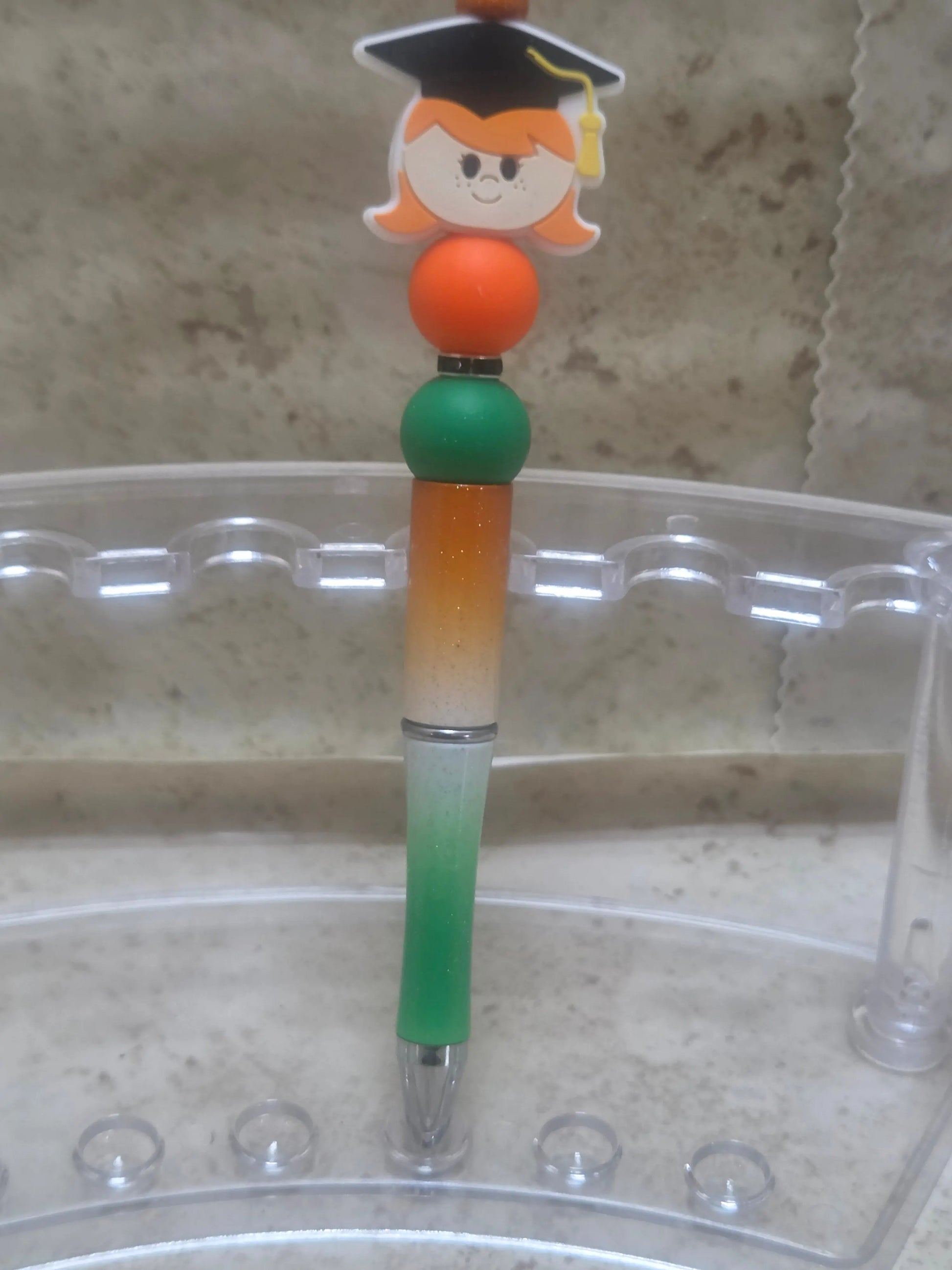Green white and orange ombre sparkly barreled graduation pen with a girl for the top - Crazy Cat Lady Crafts