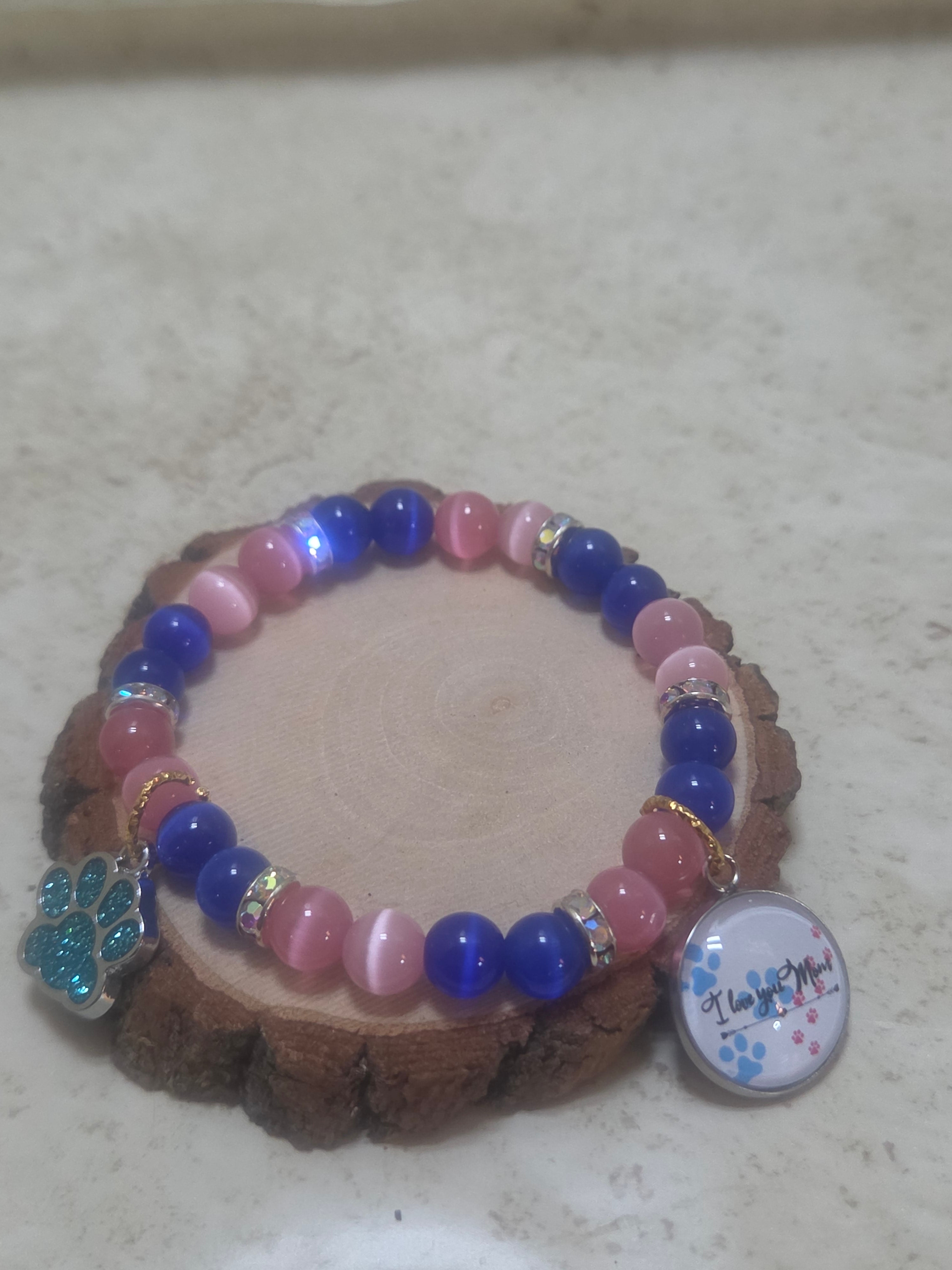 Fur baby mom mothers day bracelet in pin and blue and has 2 charms stretchy bracelet