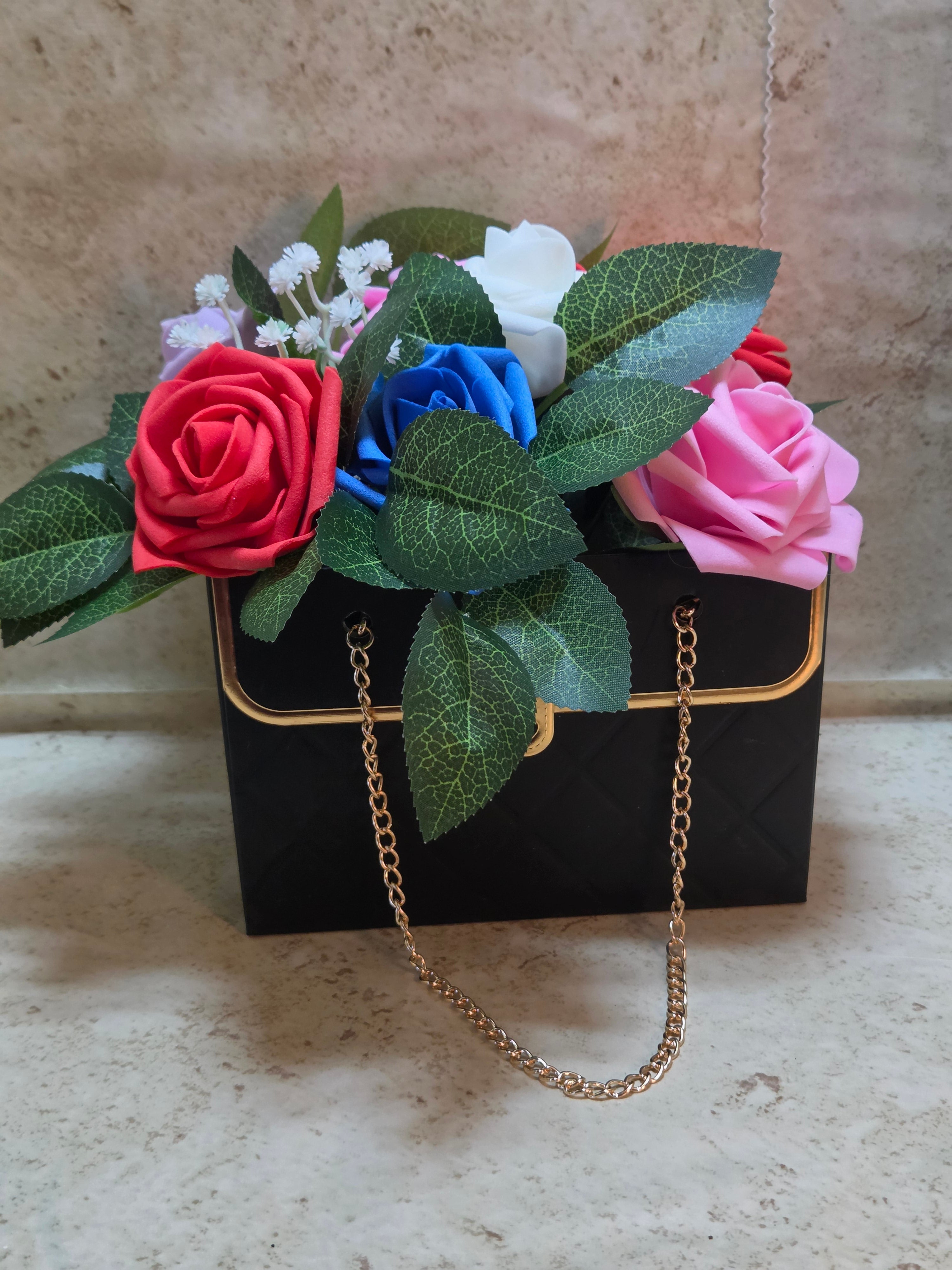 Faux purse full of assorted foam roses arrangement