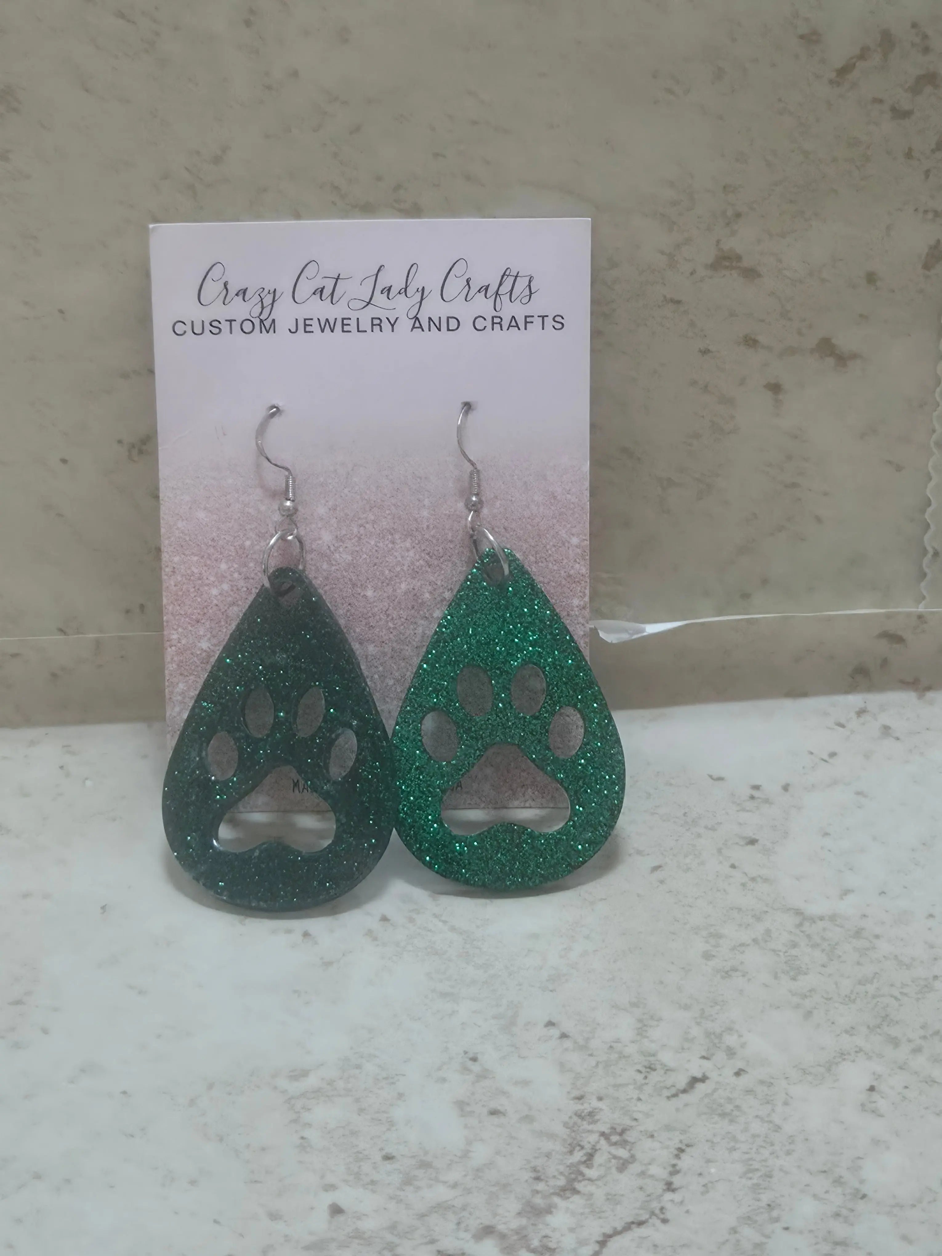custom tear drop earrings with a paw print cut out in the middle - Crazy Cat Lady Crafts
