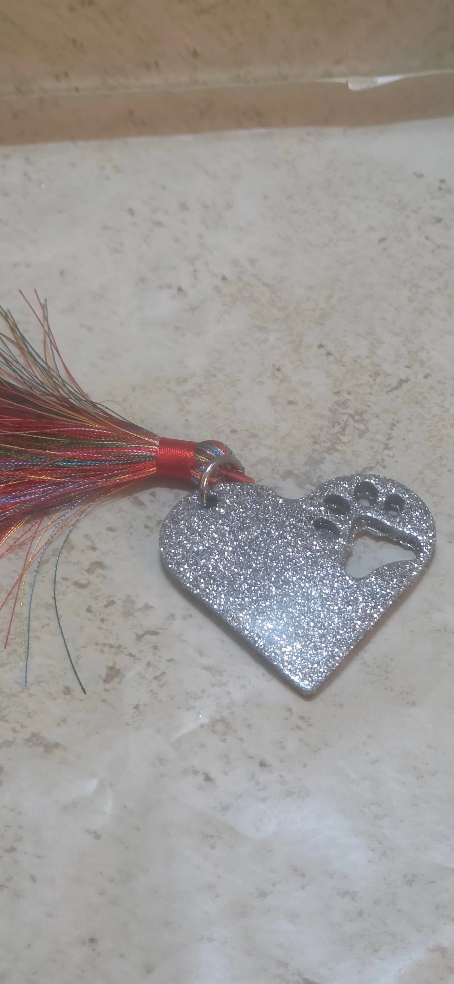 Custom heart shaped resin key chain with a paw print cut out with a multi colored tassel - Crazy Cat Lady Crafts