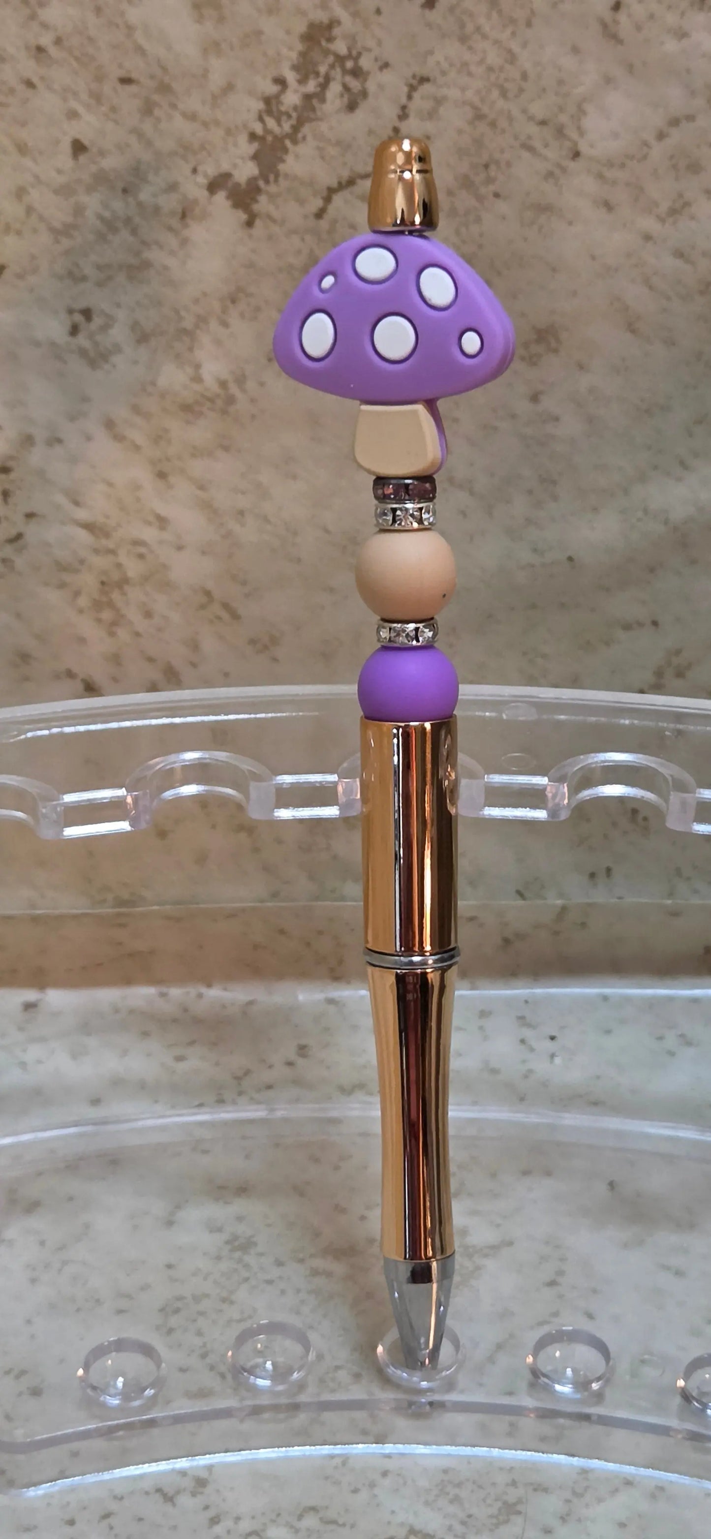 Metallic rose gold pen with beige and purple silicon beads have a purple mushroom top - Crazy Cat Lady Crafts