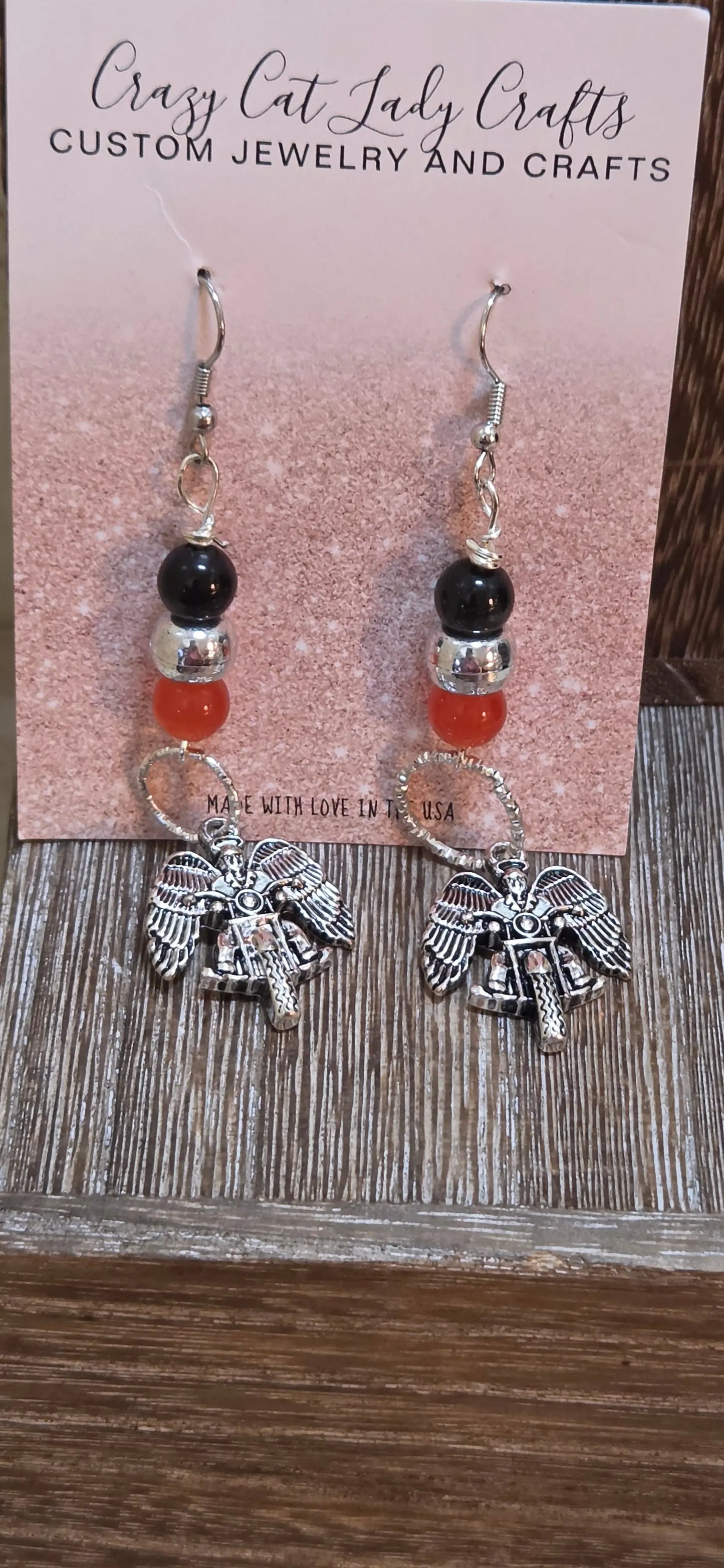 Orange silver and black beaded dangle earrings with a silver angel riding a motorcycle - Crazy Cat Lady Crafts