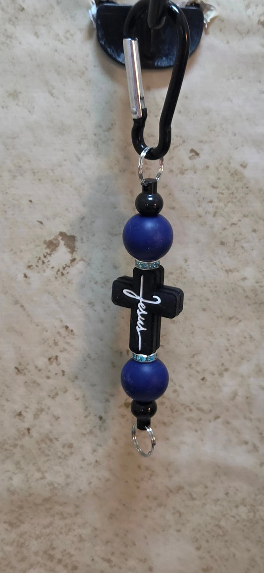 Black cross with Jesus in white silicone and blue beads bag tag - Crazy Cat Lady Crafts