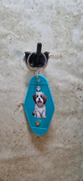 Teal colored replica of a hotel key chain with dog - Crazy Cat Lady Crafts