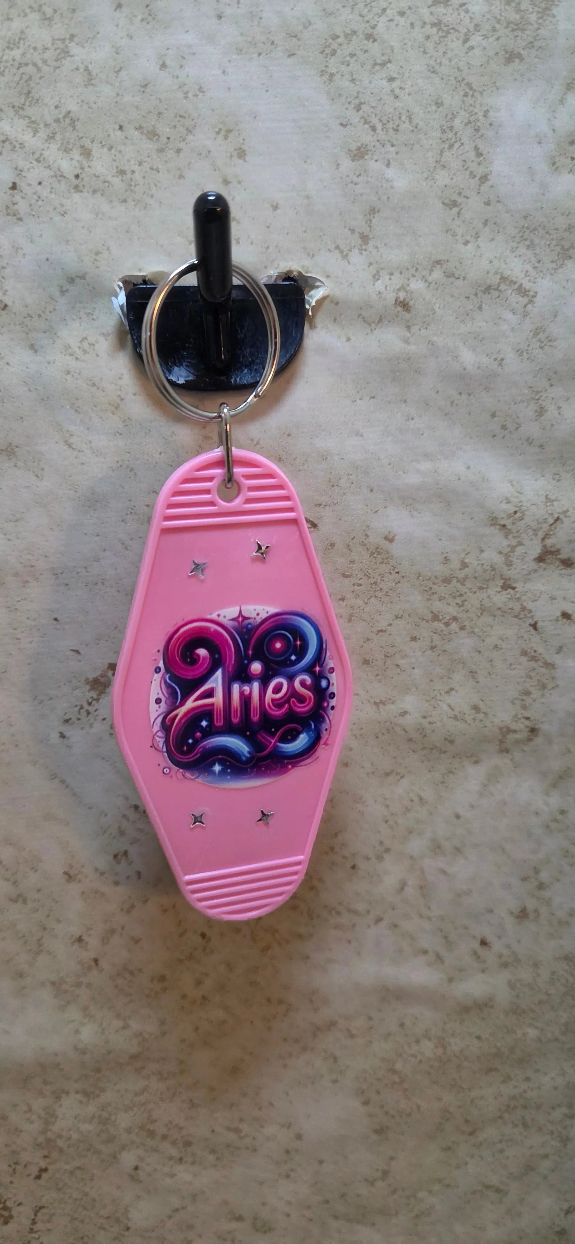 Pink replica of a hotel key rig has a Aries design on it - Crazy Cat Lady Crafts