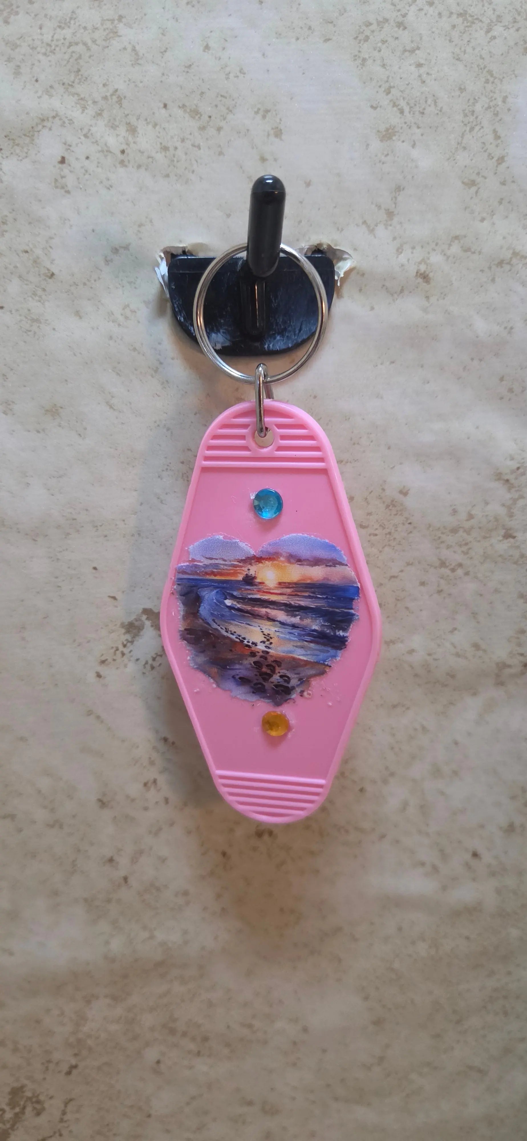 replica hotel key ring in pink and has a beach scene in a heart shape - Crazy Cat Lady Crafts