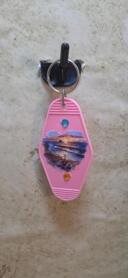 replica hotel key ring in pink and has a beach scene in a heart shape - Crazy Cat Lady Crafts