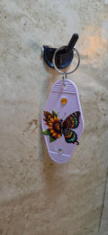 Light pink replica of a hotel key ring with a butterfly made of sunflowers - Crazy Cat Lady Crafts