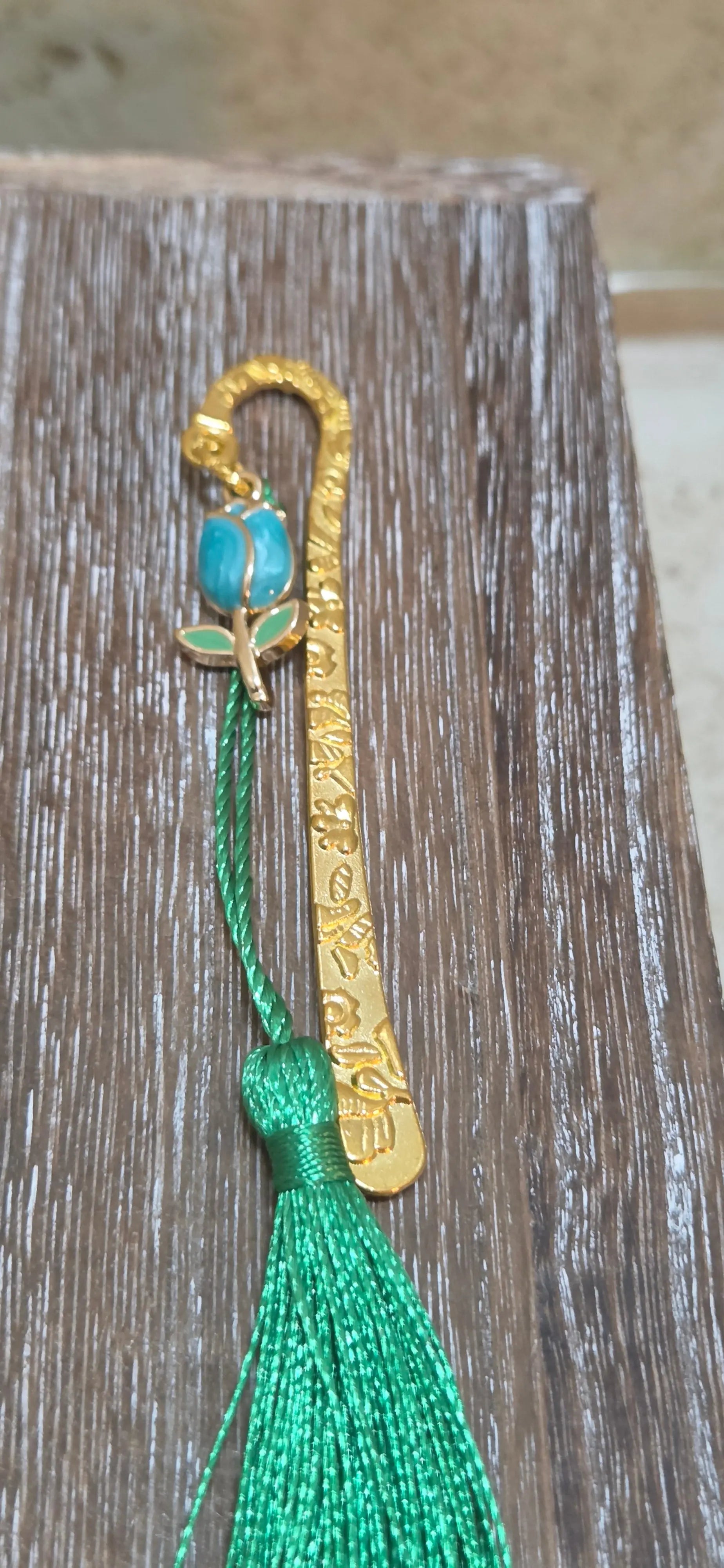 Small gold metal hook with engraved flowers and a blue tulip and green tassel bookmark - Crazy Cat Lady Crafts