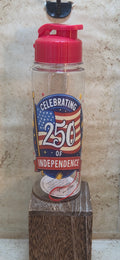 17 ounce clear water bottle with red flip top lid and strap with Celebrating 250 of independence