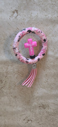 Pink floral ring with pink cross with white lettering Jesus with tassel rear view mirror ornament