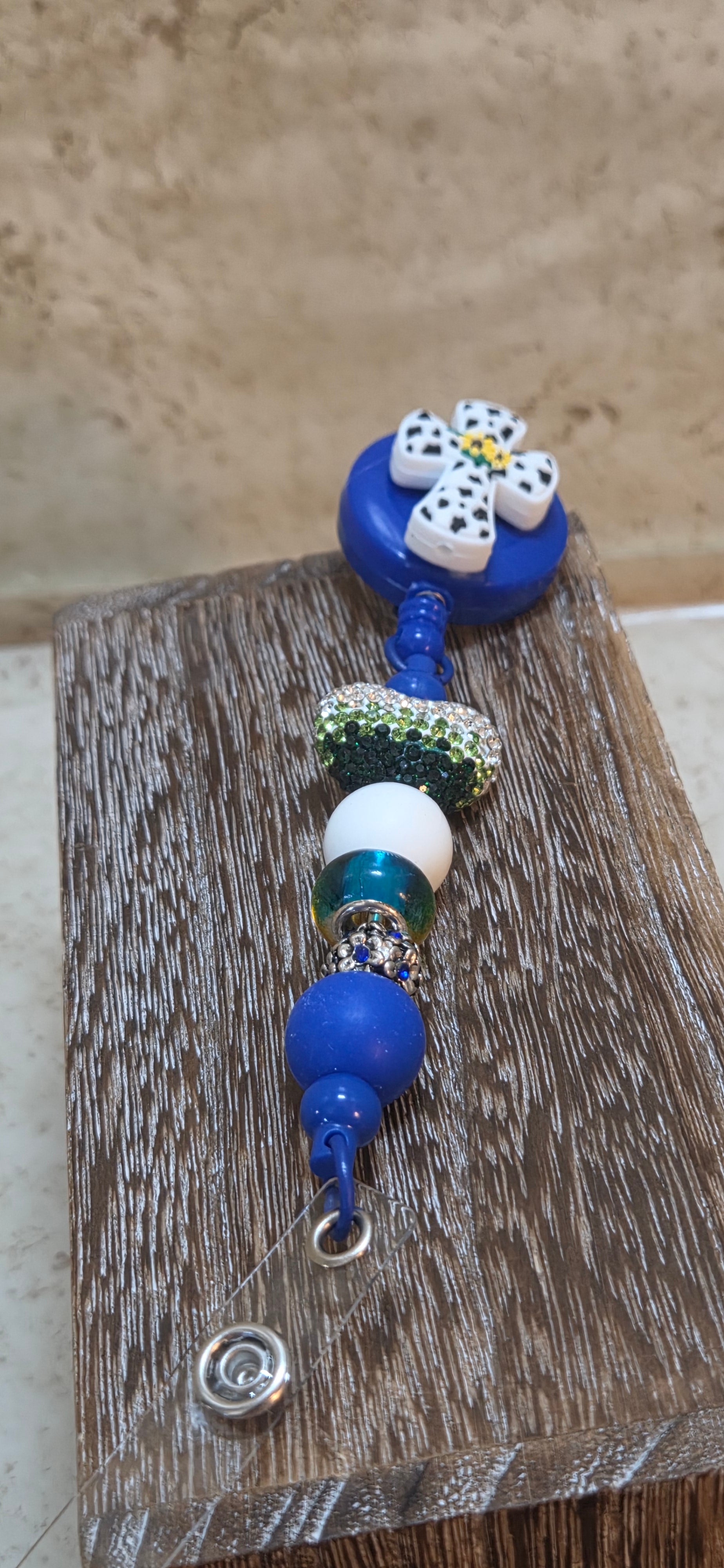 Blue with white and black cross with sunflowers in the middle beaded badge holder