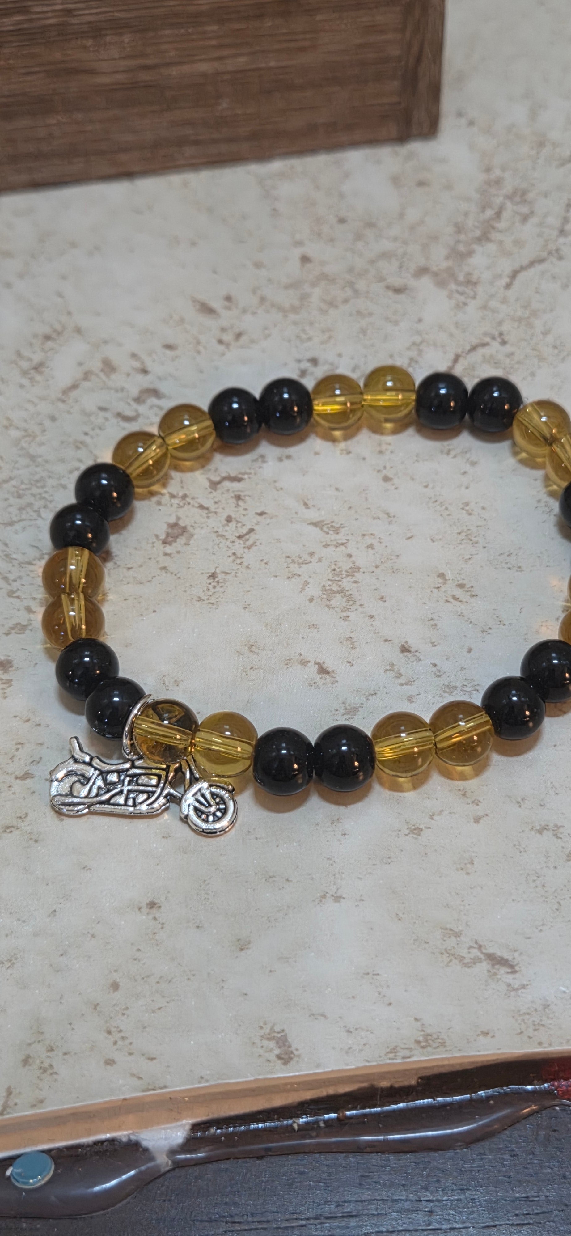 Larger size yellow and black stretchy bracelet in size 8.5 with silver motorcycle charm