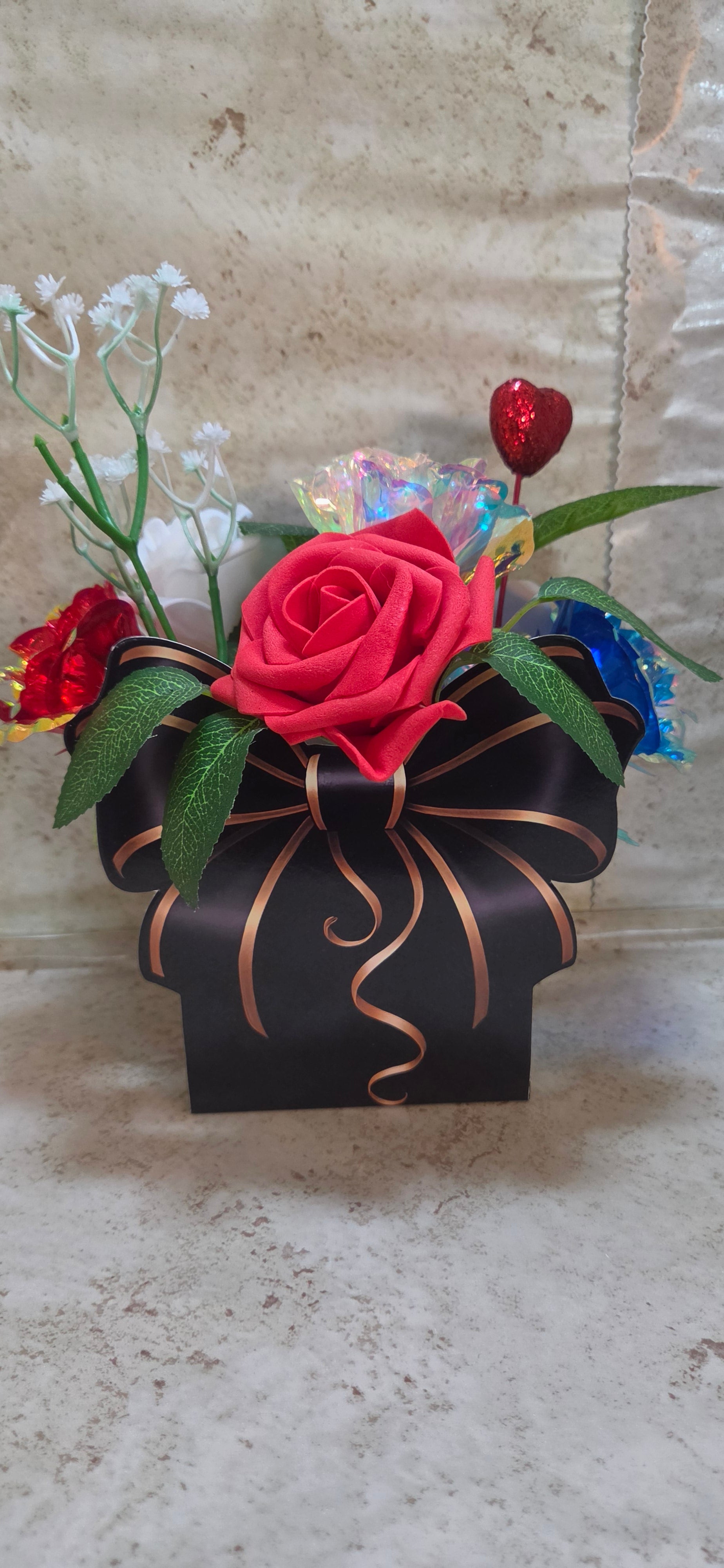 Hand designed Star Spangled bouquet of foam and tin roses in red white and blue in a black and gold bow box