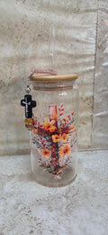 Glass tumbler with wooden top and straw with a cross and fall flowers design and straw charm with black cross and sparkly beads
