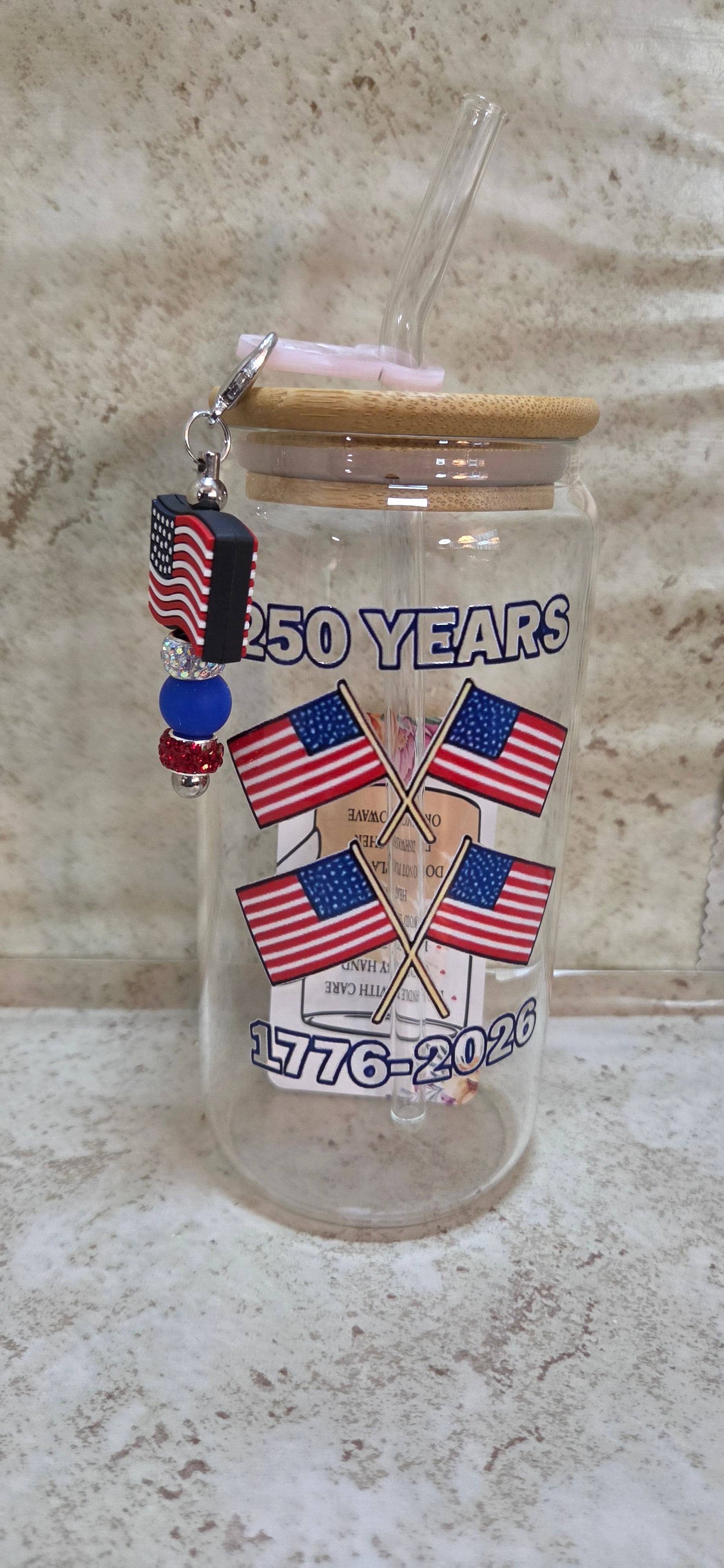 Glass america's 250th with a 4 flag design glass tumbler with wooden top and glass straw and a flag and sparkly beaded sharm