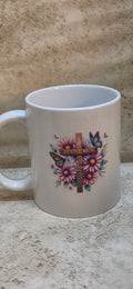 11 oz white coffee mug with a wooden cross and flowers design