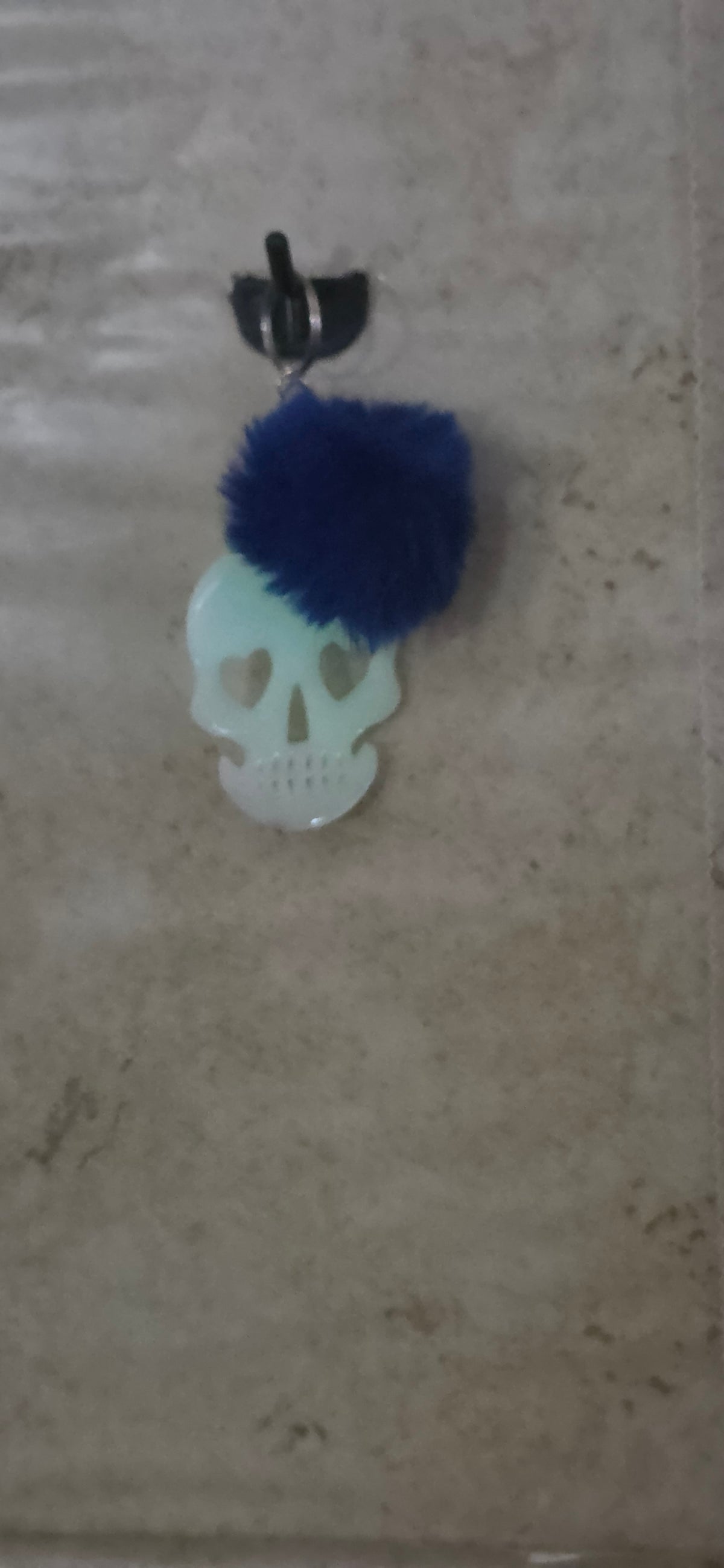 3 inch glow in the dark skull with heart eyes keychain with blue pompom