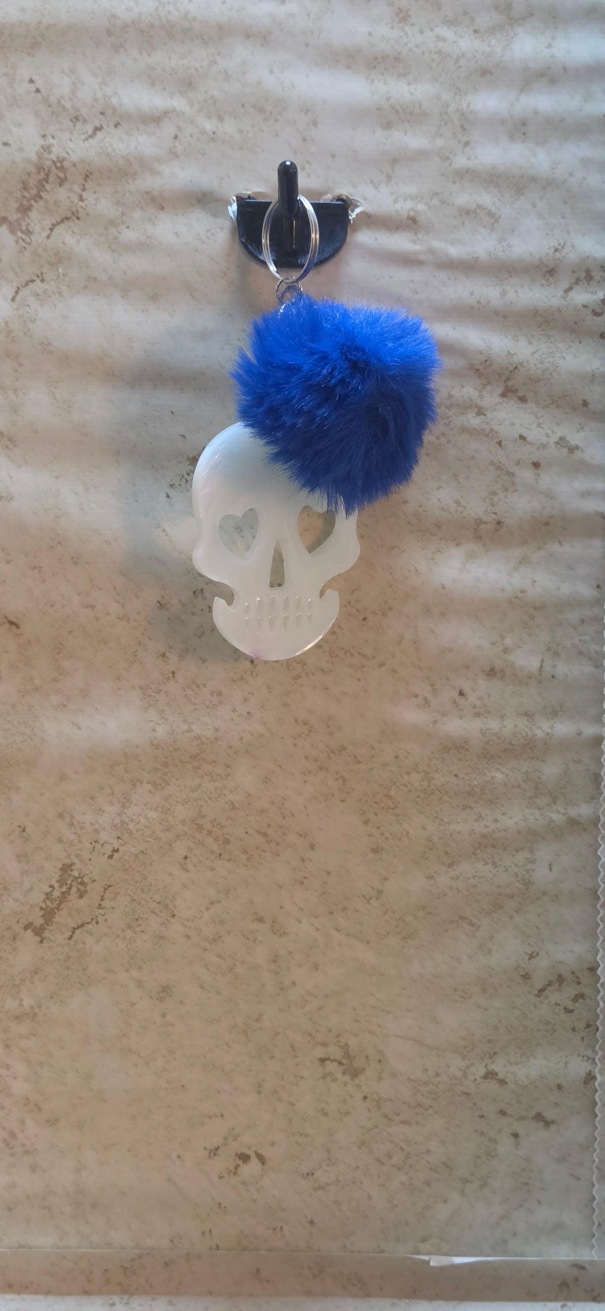 3 inch glow in the dark skull with heart eyes keychain with blue pompom