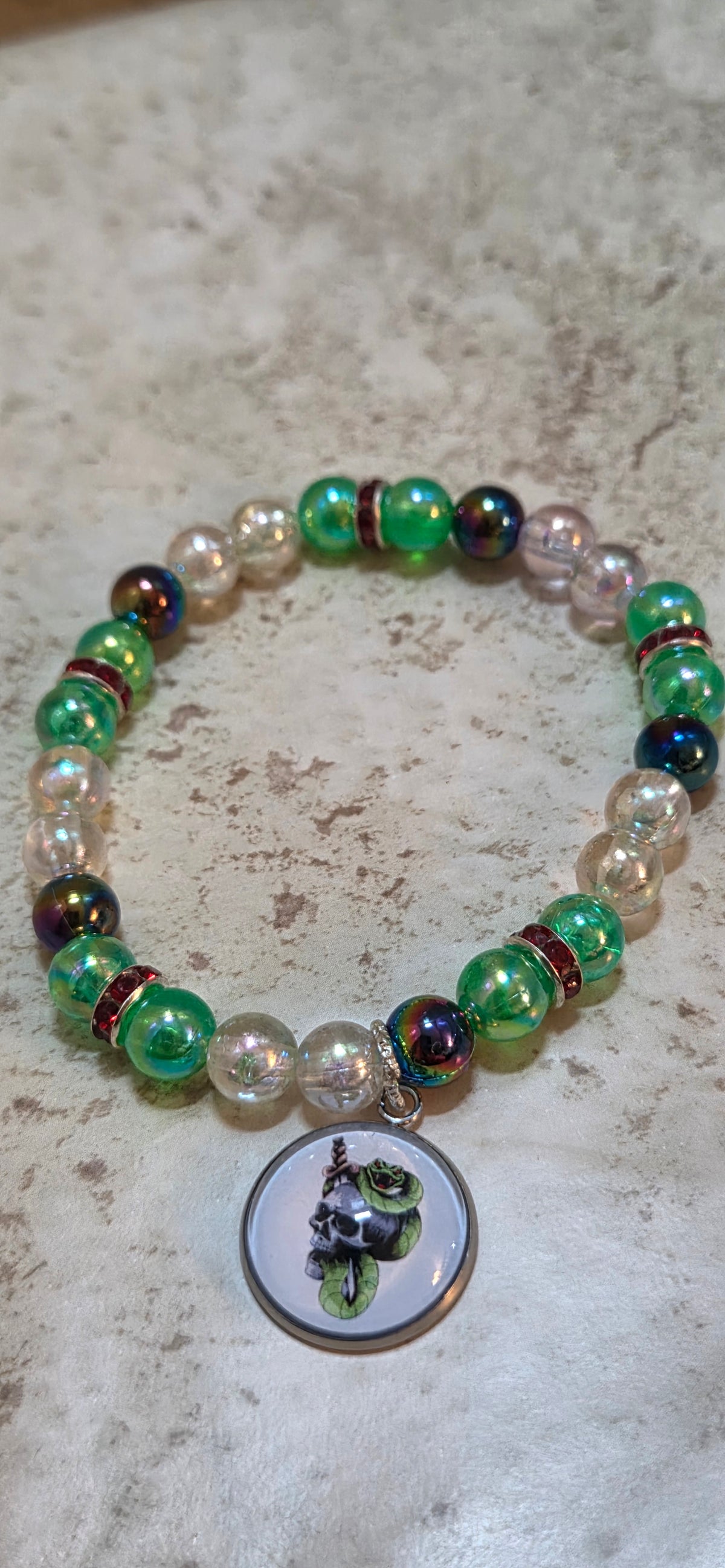 Halloween stretchy bracelet with a Green skull and snakes charm