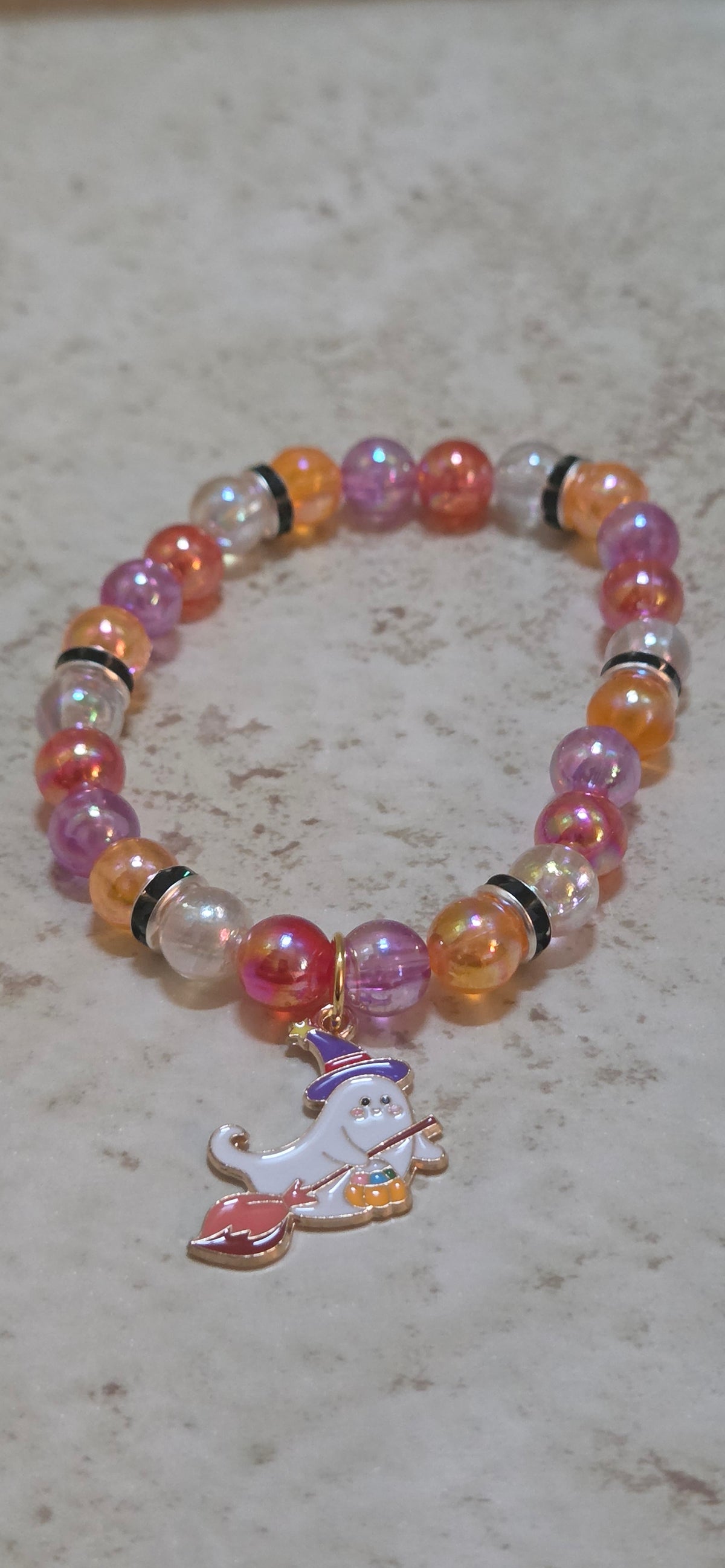 Lets sweep up Halloween with this ghost with a broom stretchy bracelet